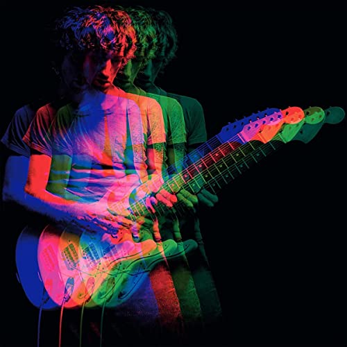 Man playing a brightly colored electric guitar, distorted with light effects.