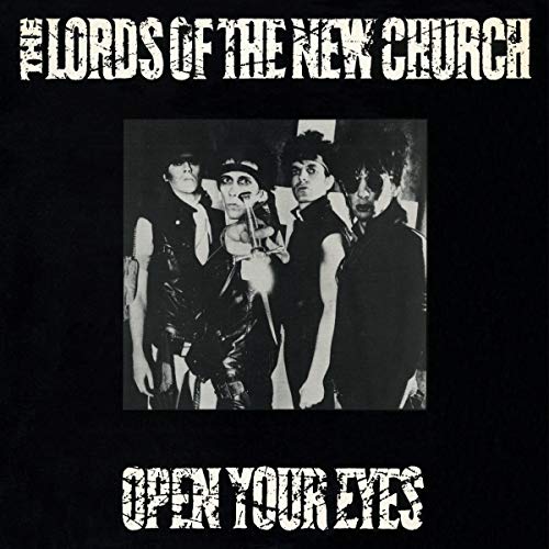 Black and white album cover featuring four figures in dark clothing.