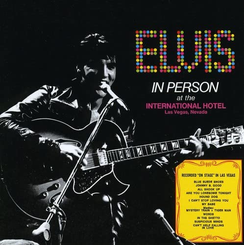 Elvis Presley playing guitar on the "Elvis In Person" CD cover.