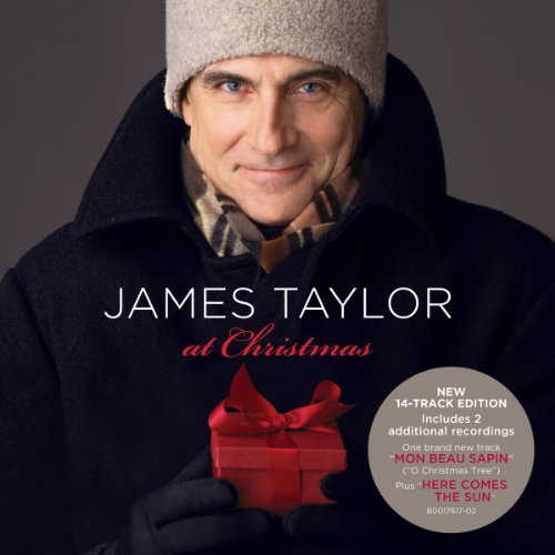 James Taylor in winter attire holding a gift, album cover for "At Christmas".