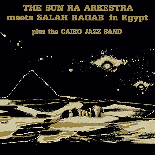 CD cover: pyramids, desert landscape, and celestial imagery in gold tones.