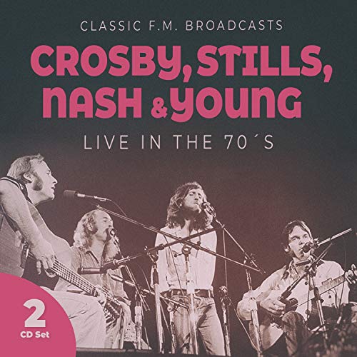 Crosby, Stills, Nash & Young performing live with guitars and microphones.