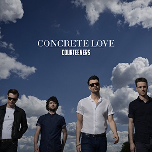 Courteeners band members stand against a blue sky with white clouds.