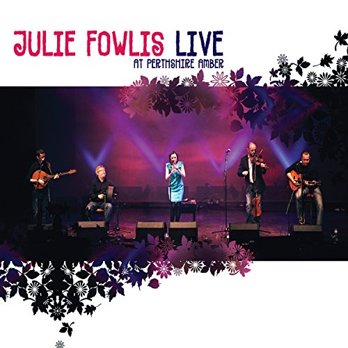 Julie Fowlis and band performing on stage with floral decorations.