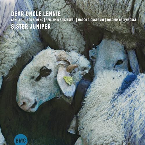 CD cover featuring close-up of sheep faces, dark blue background.