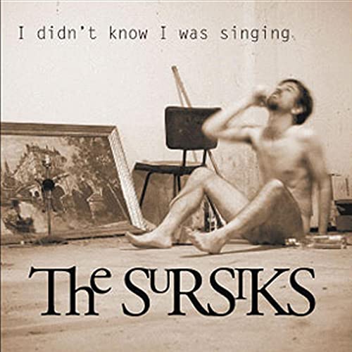 Album cover: shirtless man posing with art supplies, sepia tone.