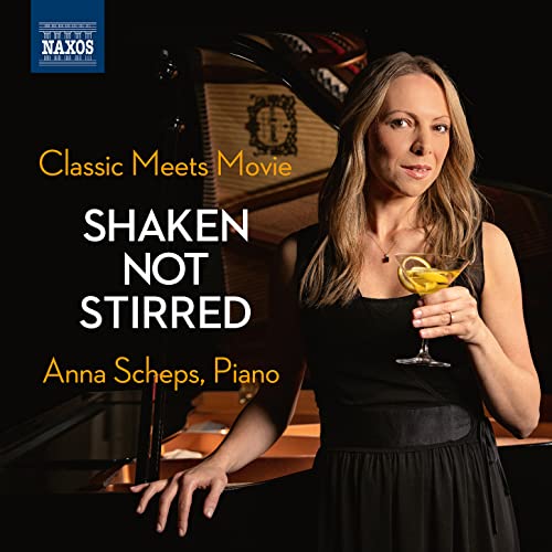 Pianist Anna Scheps with a cocktail, beside a grand piano.