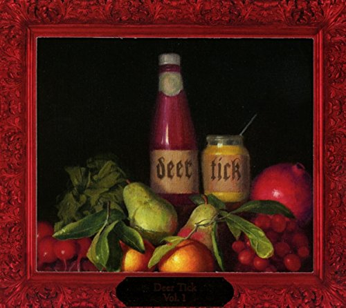 CD cover: fruit, bottles labeled “deer tick”, dark background, red frame.