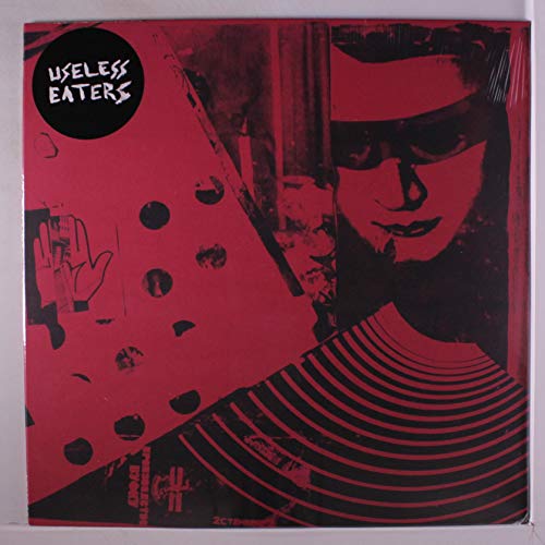 Red vinyl record cover with abstract art and a shadowed face.