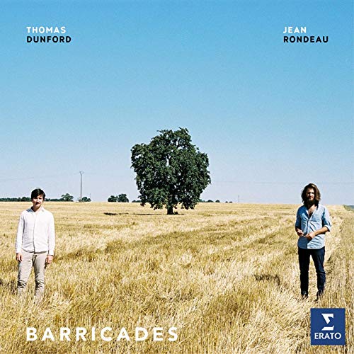 CD cover: two men in a field with a lone tree under a blue sky.