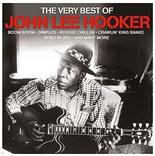 Black and white photo of John Lee Hooker playing guitar and smoking a pipe.