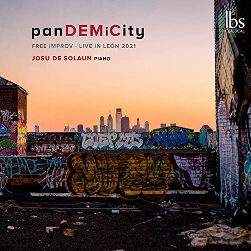 CD cover with graffiti, a skyline, and a sunset background.
