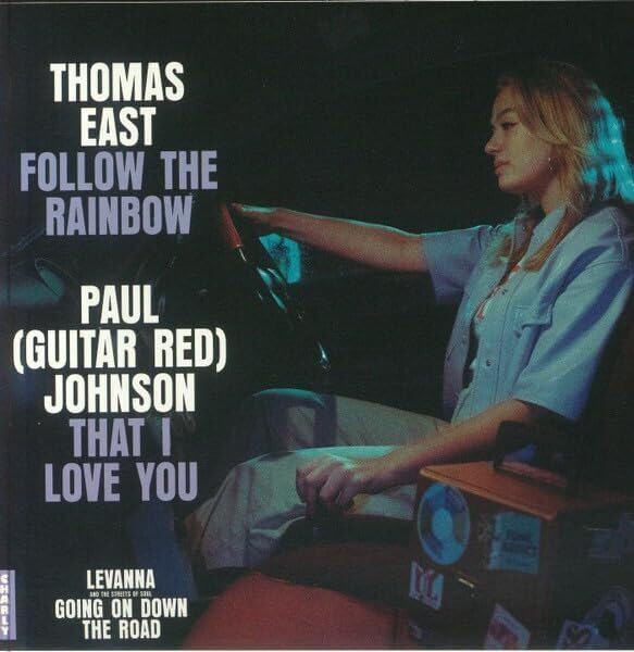 Vinyl record cover featuring a woman driving, text naming artists.