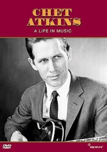 Chet Atkins portrait on DVD cover, holding a guitar, red background.