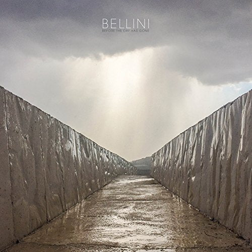 Album cover: a long, narrow concrete channel under a cloudy sky.