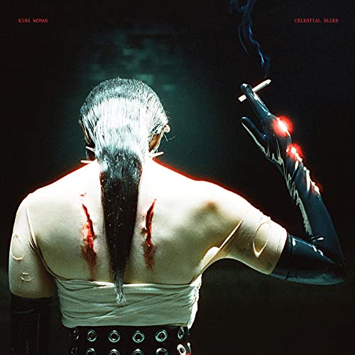 BackLined back of a person with long dark hair, bloodied scars, and black glove.