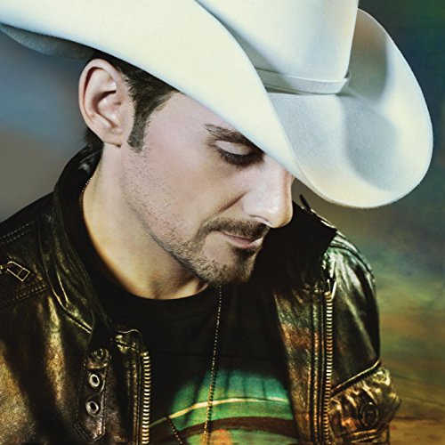 Brad Paisley in a white cowboy hat, looking downwards.