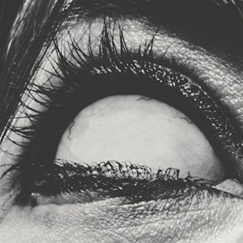 Close-up black and white image of an eye, looking upwards.