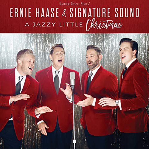 CD cover featuring four men in red suits singing into a microphone.