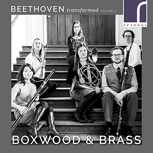 Black and white photo of five musicians with brass and woodwind instruments.