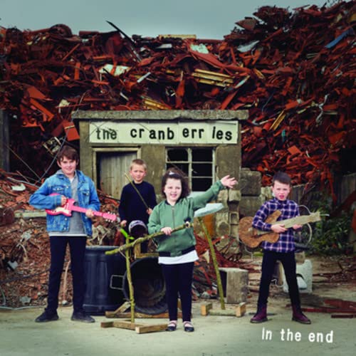 The Cranberries album cover: band members amid a scrap metal yard.
