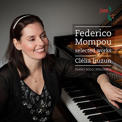 Pianist Clélia Iruzun smiles beside a grand piano, album cover for Mompou.