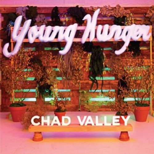 Album cover for Chad Valley’s “Young Hunger” with neon text and plants.
