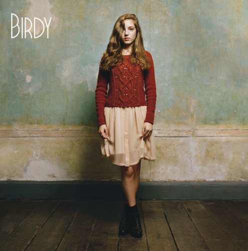 Birdy album cover: young woman in red sweater and beige skirt.