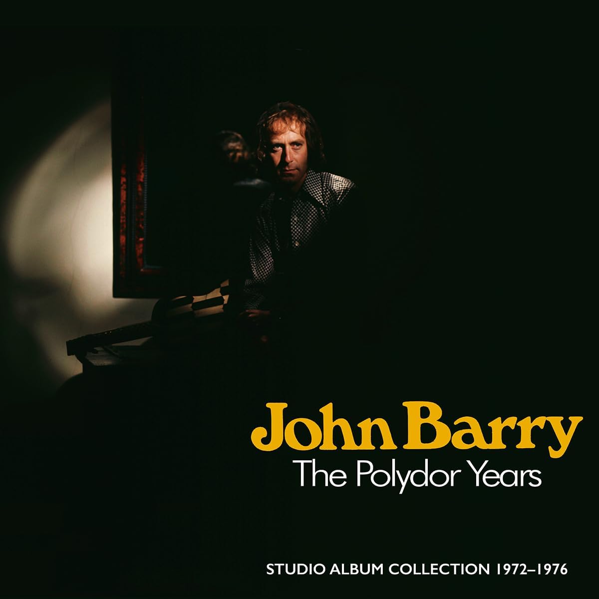 John Barry album cover featuring a portrait in shadow and gold text.