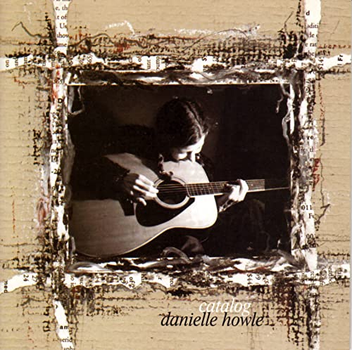 CD cover: woman playing acoustic guitar within a torn paper frame.
