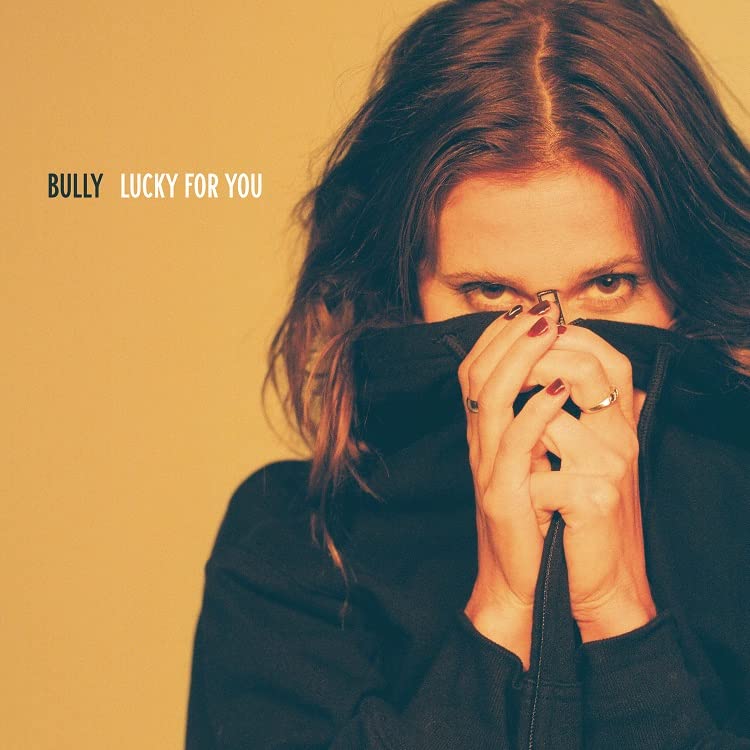 Album cover for Bully’s “Lucky For You” featuring a woman’s face.
