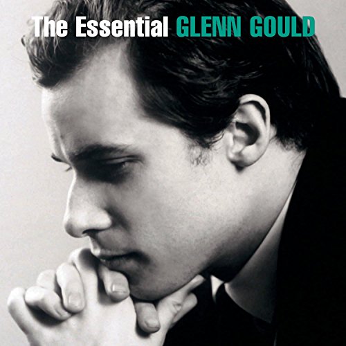 Black and white portrait of pianist Glenn Gould with hands clasped.