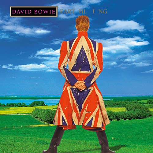 David Bowie standing with back to viewer in Union Jack coat, landscape.