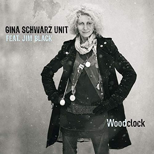 CD cover featuring a woman with curly hair in a dark coat.