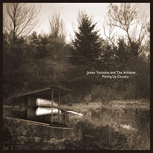 Sepia-toned album cover with a small shed and canoes in a wooded area.