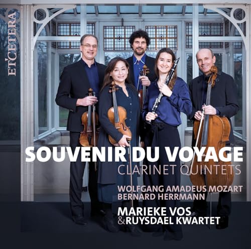 Classical musicians with instruments pose in front of a glass conservatory.