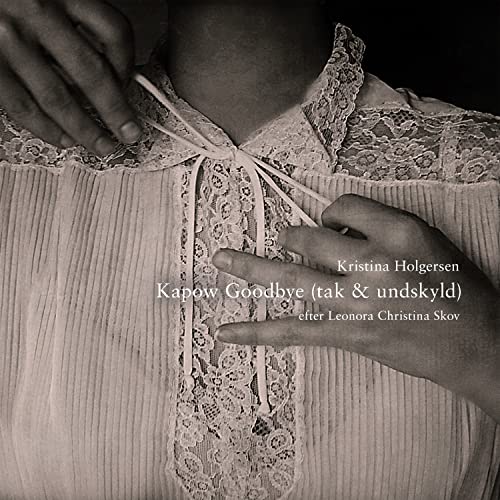 Close-up of hands fastening a delicate lace collar, black and white.