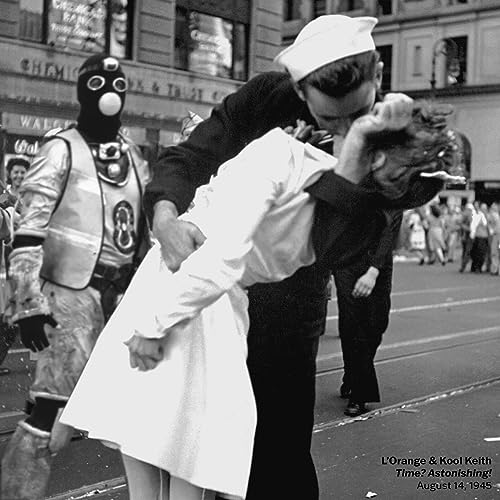Black and white photo of a couple kissing, with a figure in a mask.