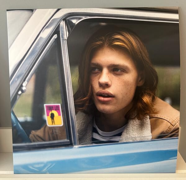 Vinyl record cover featuring a young man looking out a car window.