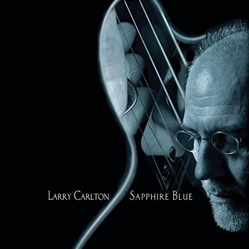 Larry Carlton’s “Sapphire Blue” CD cover with a portrait and guitar.