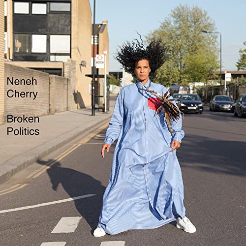 Neneh Cherry album cover: woman in blue dress crossing a street.