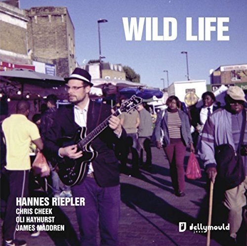 CD cover: Hannes Riepler with musicians in a busy street scene.