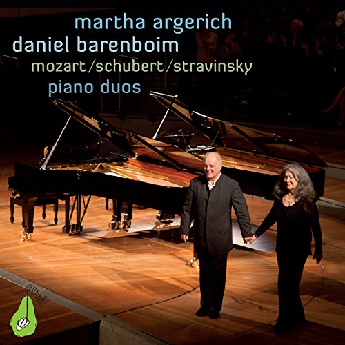 Martha Argerich and Daniel Barenboim with two grand pianos on stage.
