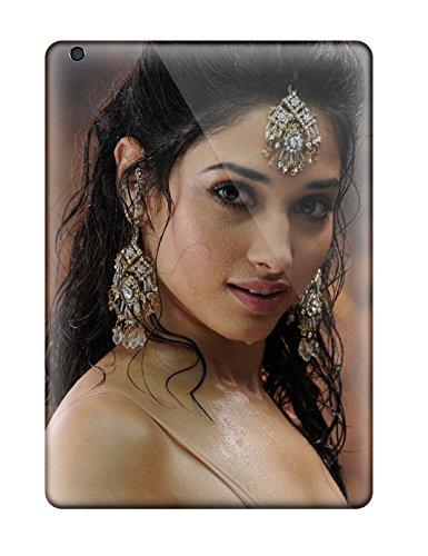 A close-up portrait of a woman with wet hair wearing ornate jeweled head and earrings.