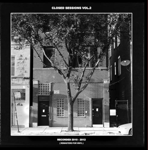 Black and white album cover featuring a tree in front of buildings.