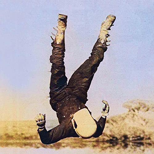 Person falling through the air wearing a helmet and boots.