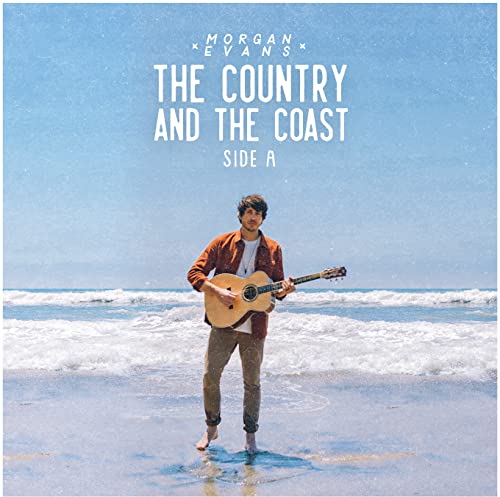 CD cover: man with guitar on a beach, blue sky.