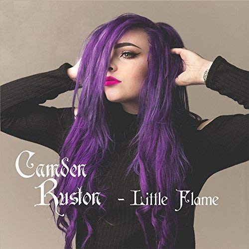 CD cover featuring a woman with long purple hair against a beige background.