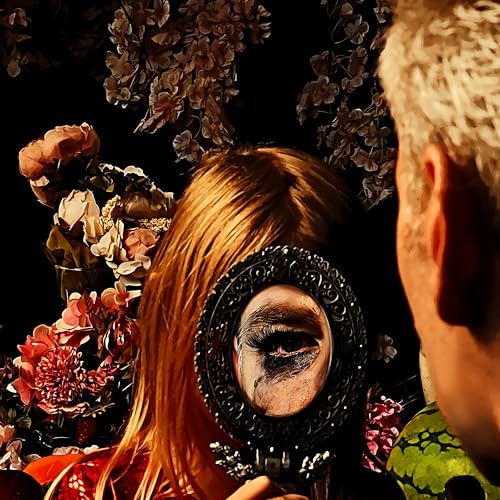 Person holding ornate mirror reflecting a tearful eye, surrounded by flowers.