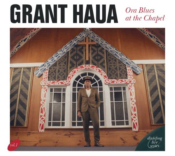 CD cover featuring Grant Haua standing before a carved wooden chapel.